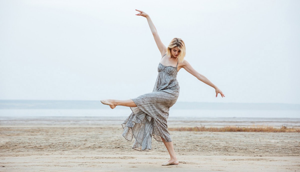 woman dancing beach